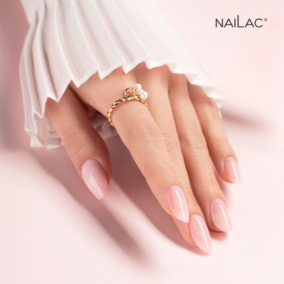Manicure żelowy. Paznokcie ozdobione żelem w butelce Jelly Bottle Bling Lolita w odcieniu różowym ze złotymi drobinkami