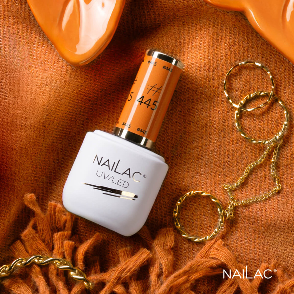 Butelka z lakierem hybrydowym w kolorze pomarańczowym Butelka z lakierem hybrydowym w kolorze pomarańczowym